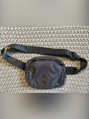 Black Gaian Wander waist/crossbody pack w/ circular Mandala logo on the front